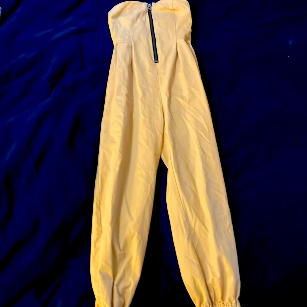 This is a medium size yellow strapless jumpsuit from Urban Outfitters